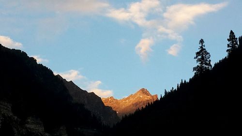 Scenic view of mountains against cloudy sky