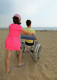 Rear view of people on beach