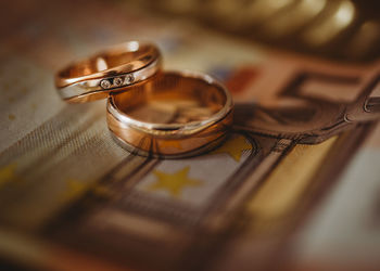 Close-up of wedding rings on table