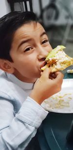 Portrait of boy eating food
