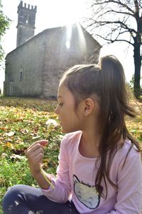 Close-up of girl sitting outdoors