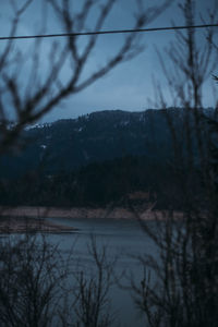 Scenic view of lake against sky at dusk