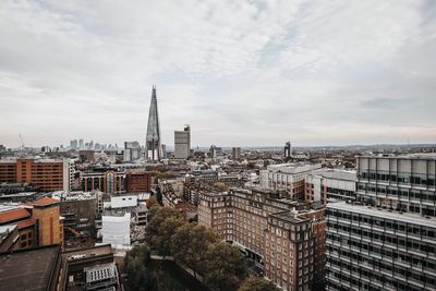 High angle view of buildings against cloudy sky