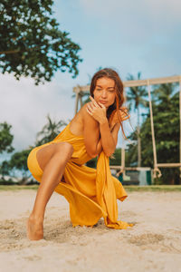 Portrait of young woman dancing on the beach 