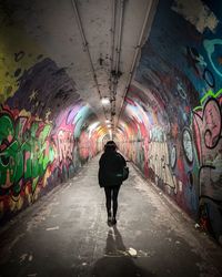 Rear view of man standing in tunnel