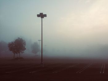 Street light by road against sky