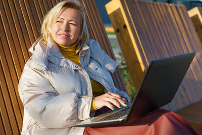 Young woman using laptop at home