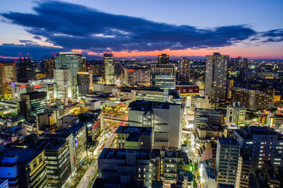 High angle view of buildings in city against cloudy sky