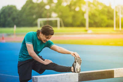 Young man exercising at stadium