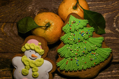 Overhead view of gingerbread cookies with oranges on table