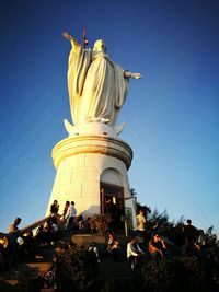 Low angle view of statue against blue sky