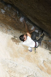 High angle view of man surfing on rock