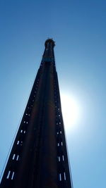 Low angle view of skyscraper against clear blue sky