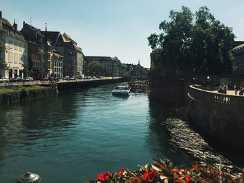 Canal amidst buildings against sky