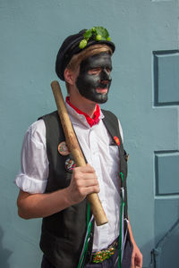 Full length of man standing against wall