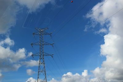 Low angle view of electricity pylon against sky