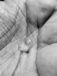 Close-up of hand on water