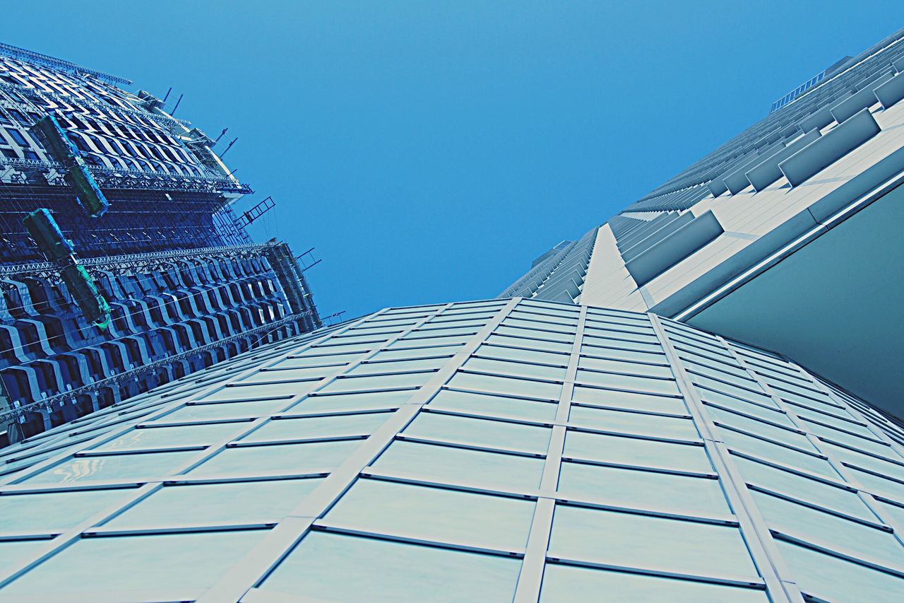 architecture, built structure, building exterior, low angle view, clear sky, tall, skyscraper, tall - high, tower, city, office building, modern, repetition, directly below, day, blue, outdoors, sky, geometric shape, diminishing perspective, no people, building story, office block