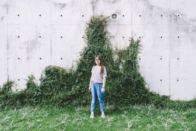 Rear view of woman standing on grass