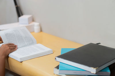 Midsection of woman using laptop on table
