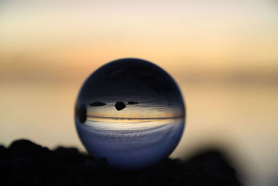 Close-up of crystal ball on rock