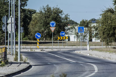 Road sign against trees