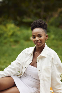 Smiling woman sitting in park