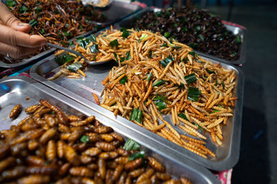 High angle view of person taking food from tray