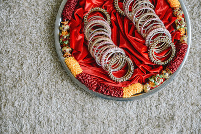 High angle view of red chili peppers on rug