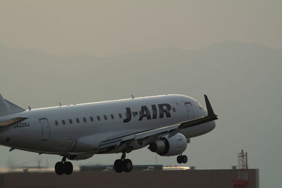 Airplane on runway against sky