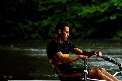 Athlete rowing on river