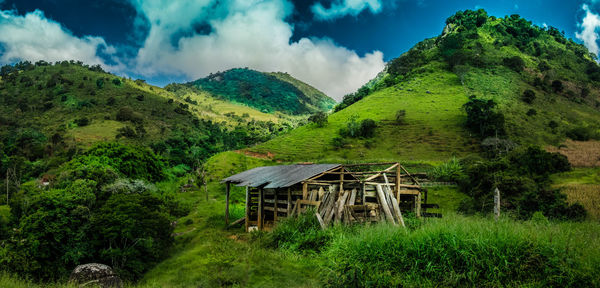 Scenic view of green mountains against sky