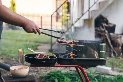 Man preparing food on barbecue grill