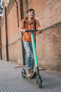 Smiling man on push scooter