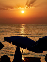 Scenic view of sea against orange sky during sunset