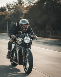 Man riding motorcycle on road