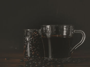 Close-up of wine glass on table against black background