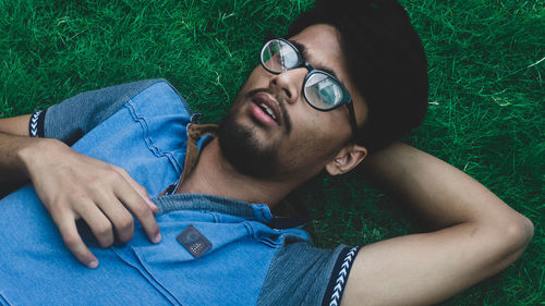 Portrait of young man lying down on land