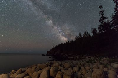 Scenic view of rocks at night against sky