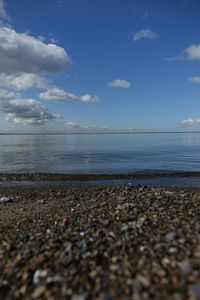 Scenic view of beach against cloudy sky
