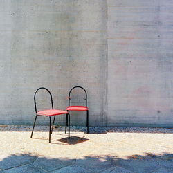Empty chair against wall