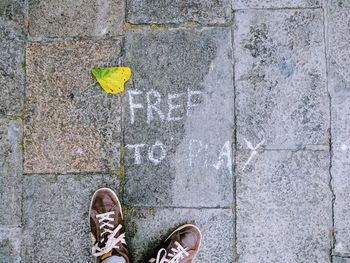 Low section of man standing on footpath