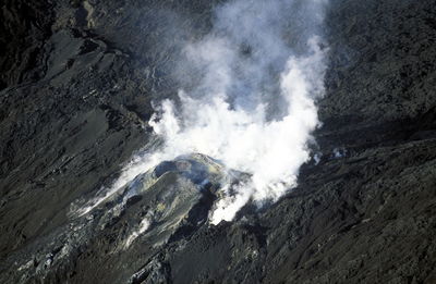 Aerial view of smoke emitting from mountain