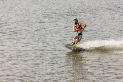 Full length of a man jumping in lake