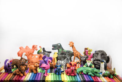 Close-up of toys on table against white background