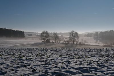 Scenic view of snowy field against clear sky