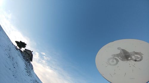 Low angle view of snow against blue sky