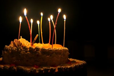 Close-up of birthday cake against black background