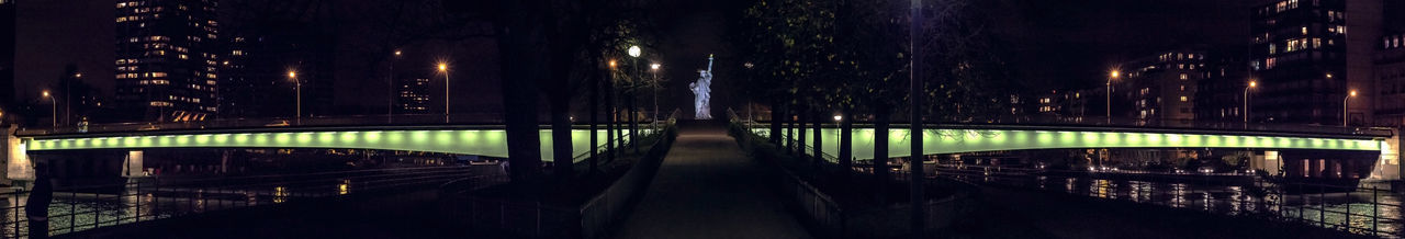 Bridge over illuminated city at night