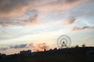 Silhouette ferris wheel against sky during sunset